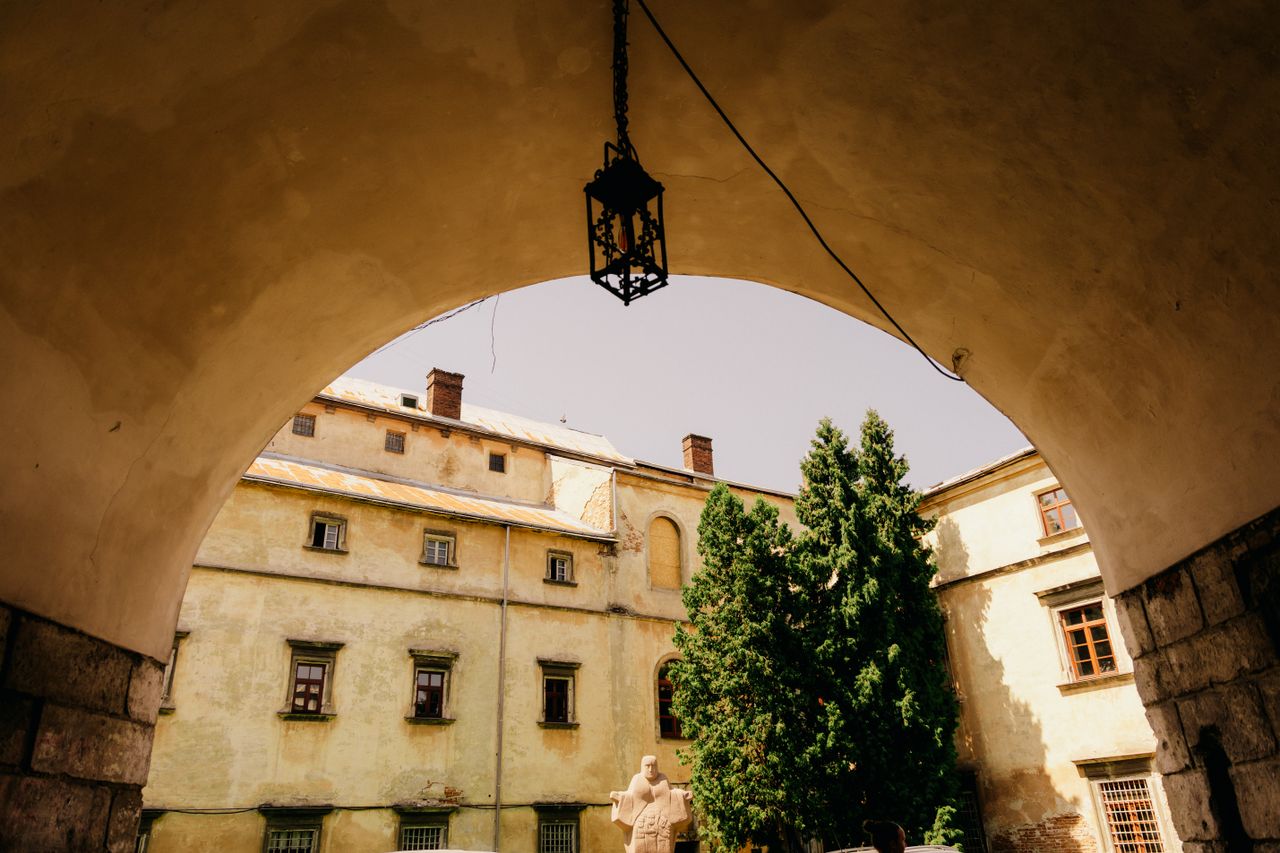 Explore the architectural beauty of a historic courtyard in Lviv, bathed in warm sunlight.