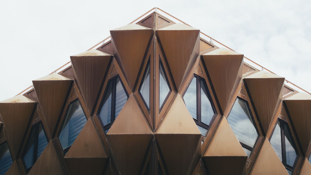 A stunning geometric facade featuring triangular shapes on a modern building in Staoueli, Algiers.